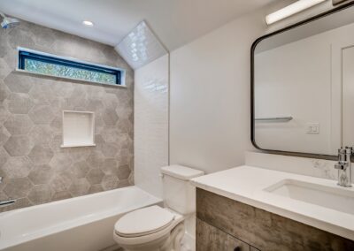 a bathroom with a commode and bathtub