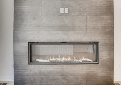view of a fireplace and a gray wall