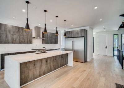a kitchen area with cabinets and lights