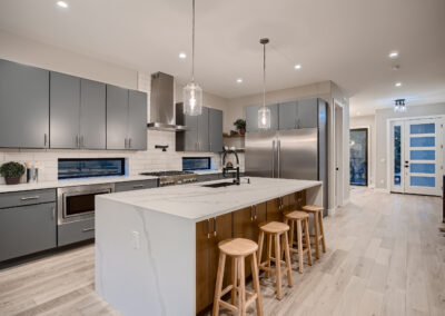 Kitchen area with four stools and an island